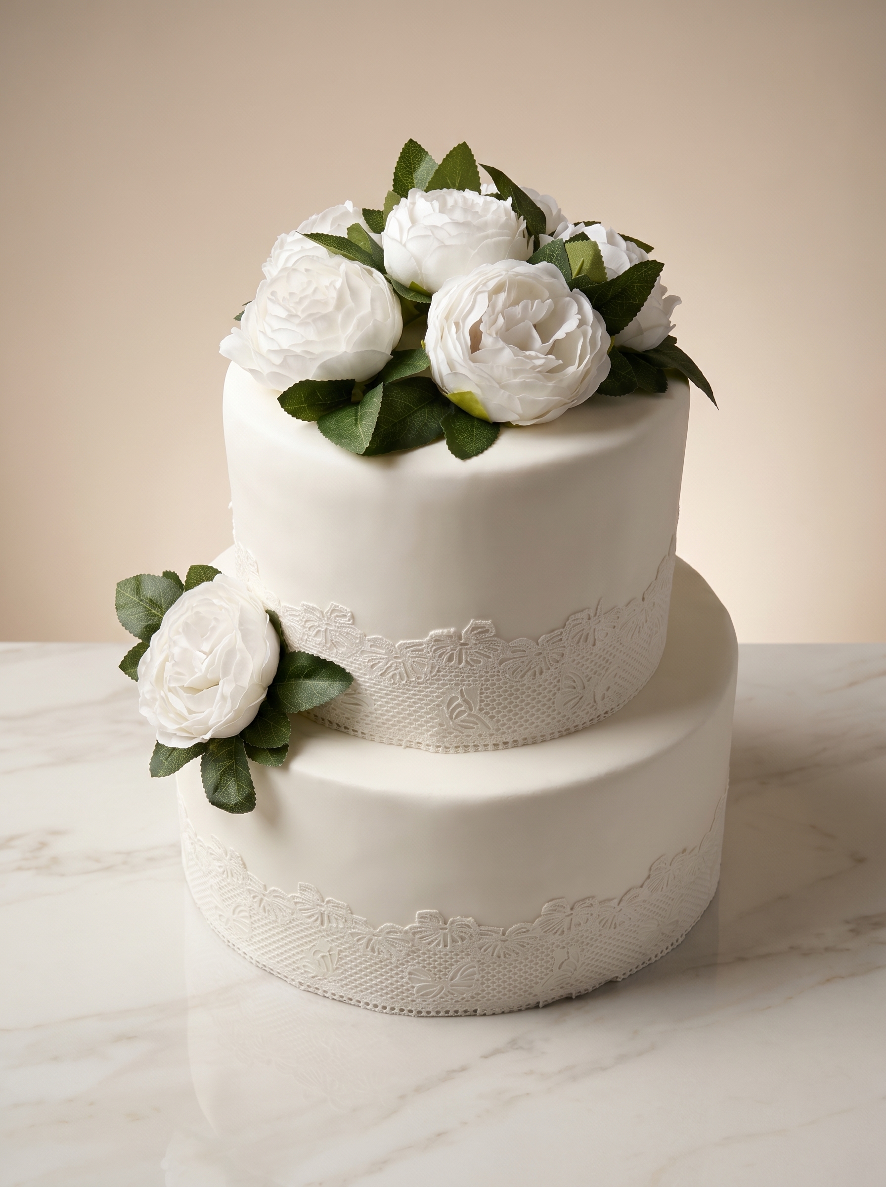 Elegant two-tier white wedding cake with peonies